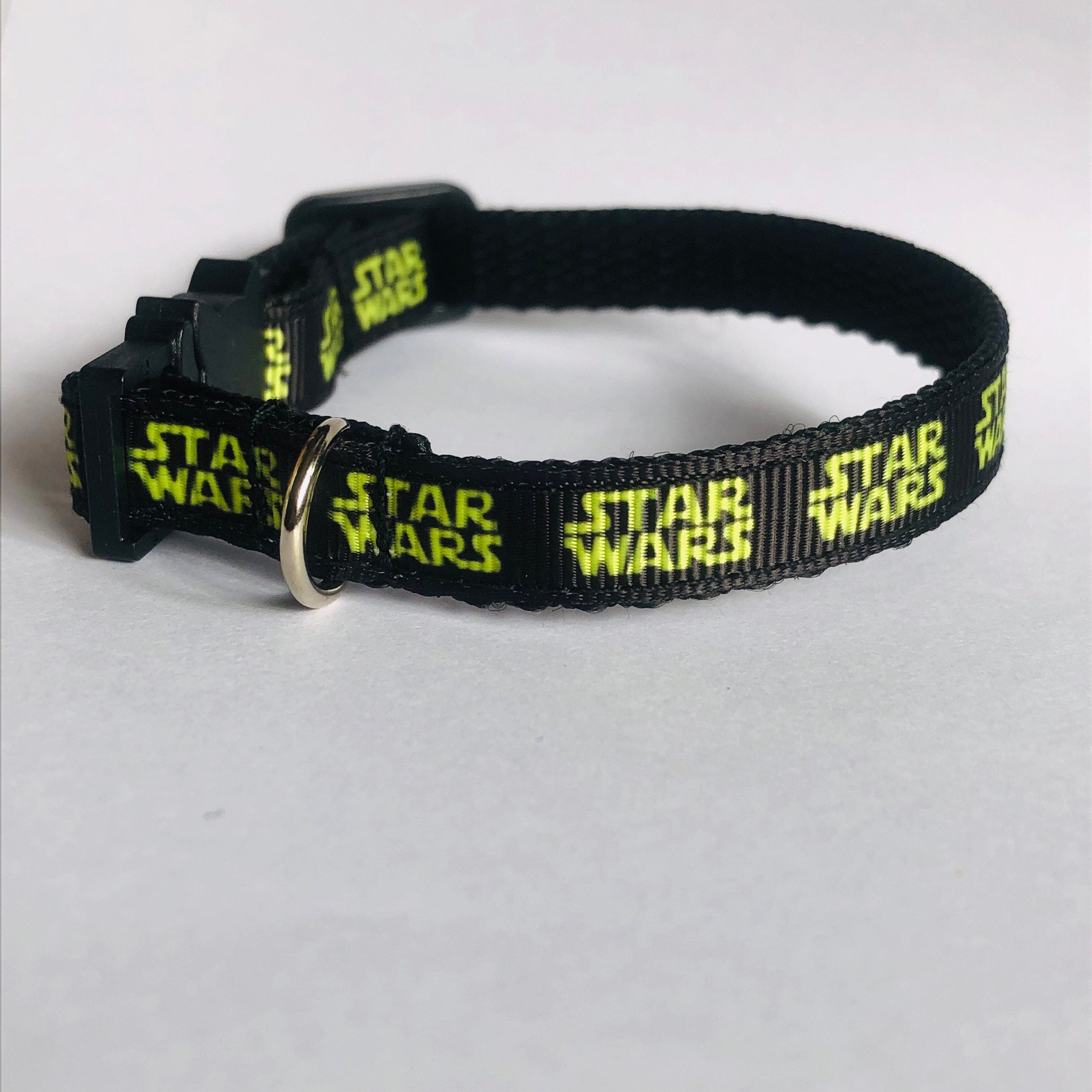 Black cat collar with 'Star Wars' text on a white background