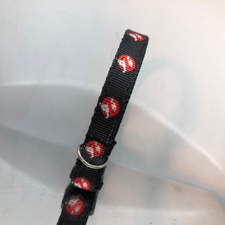 Black collar with red and white designs on a white background
