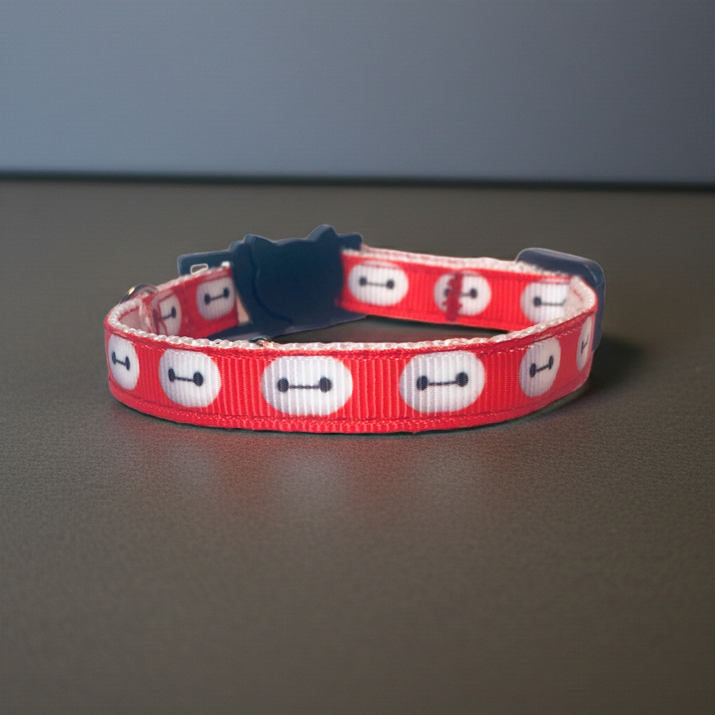 Red cat collar with white character pattern on a gray surface