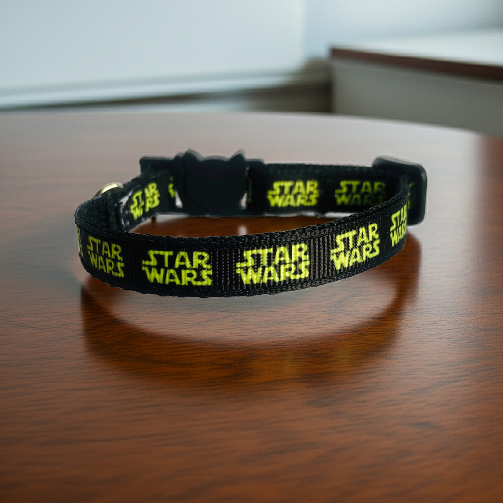 Black 'Star Wars' branded cat collar on a wooden surface