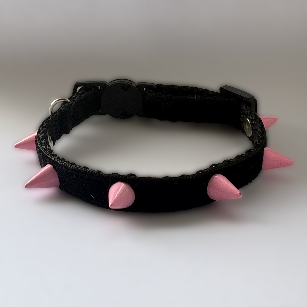 Black cat collar with pink spikes on a white background