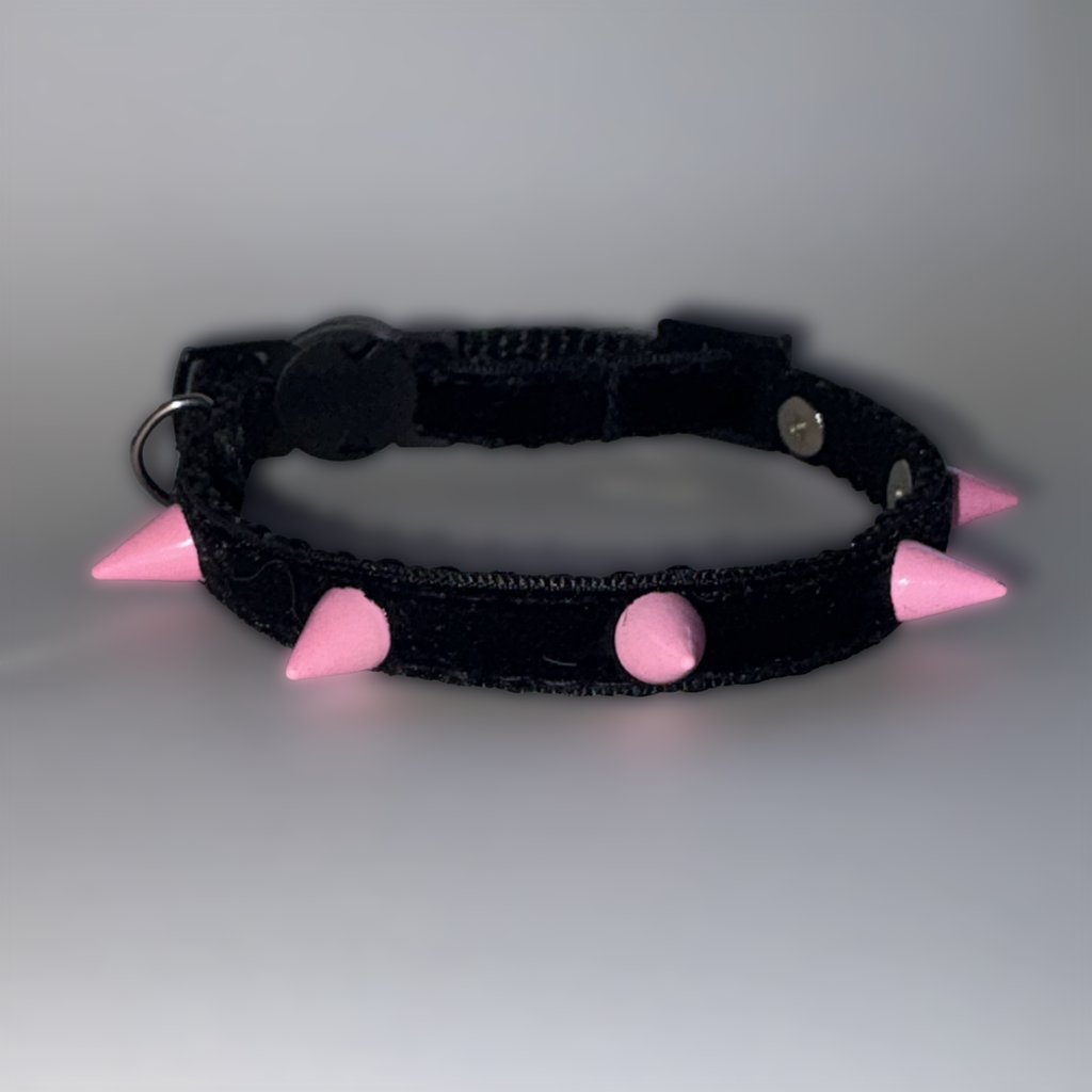 Black collar with pink spikes on a gray background
