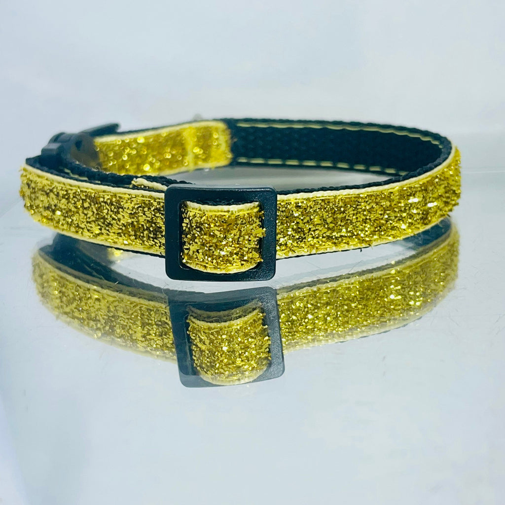 Gold glittering cat collar reflected on a white background