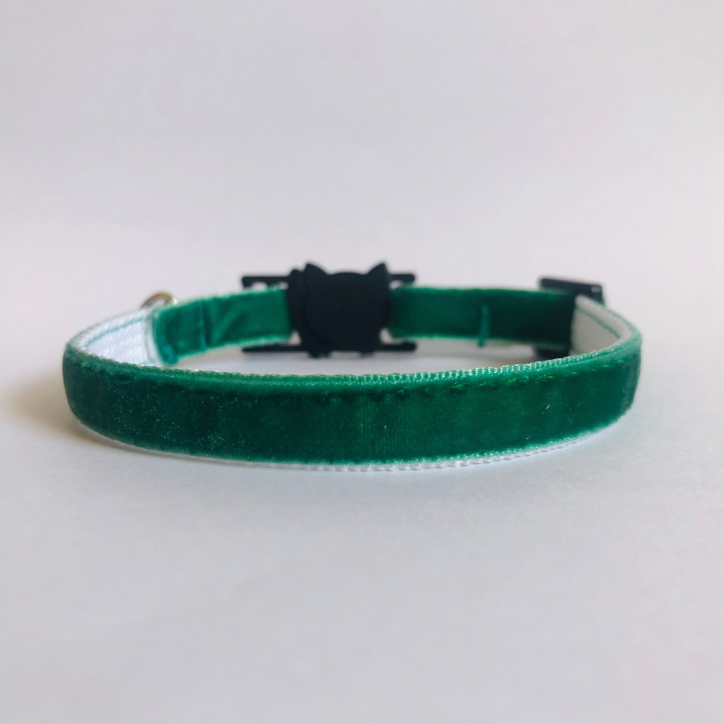 Green velvet collar with a black clasp on a light gray background